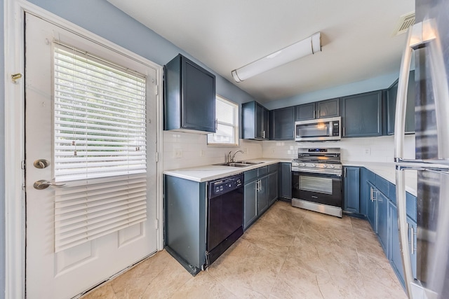 12511 Garden Gale Ln, Houston, TX 77044 - kitchen with stainless steel appliances, light countertops, decorative backsplash, and blue cabinetry