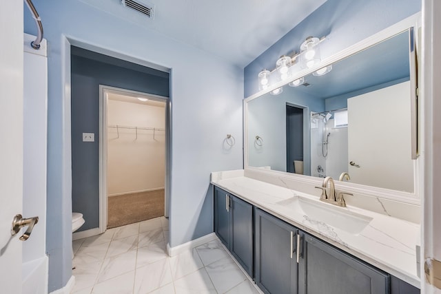 12511 Garden Gale Ln, Houston, TX 77044 - bathroom featuring a spacious closet, marble finish flooring, vanity, and a shower