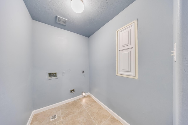 12511 Garden Gale Ln, Houston, TX 77044 - laundry area with electric dryer hookup, washer hookup, light tile patterned floors, a textured ceiling, and gas dryer hookup
