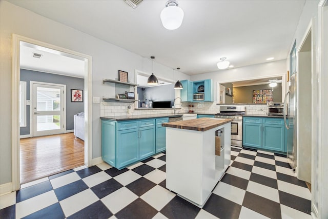 308 W 33rd St, Houston, TX 77018 - kitchen with butcher block countertops, blue cabinetry, appliances with stainless steel finishes, and light flooring