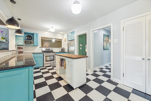 308 W 33rd St, Houston, TX 77018 - kitchen featuring stainless steel appliances, light flooring, butcher block countertops, tasteful backsplash, and open shelves