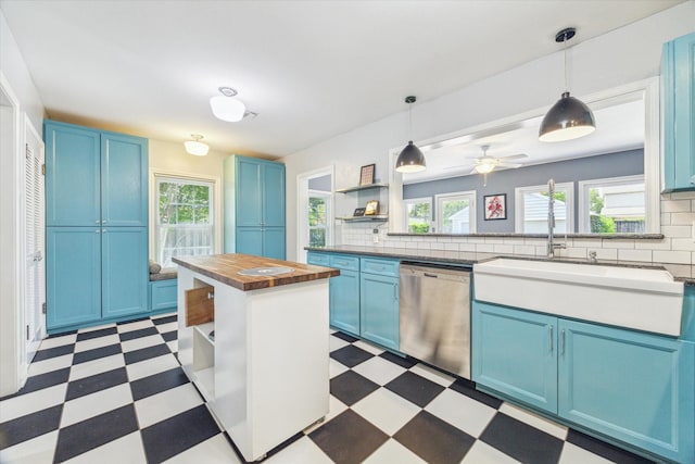 308 W 33rd St, Houston, TX 77018 - kitchen featuring blue cabinets, dishwasher, and light flooring