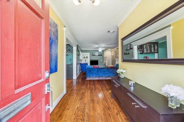 308 W 33rd St, Houston, TX 77018 - entryway featuring wood finished floors, a ceiling fan, and ornamental molding