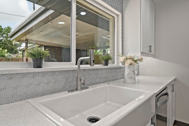 5425 Viking Dr, Houston, TX 77092 - kitchen view of white cabinetry, light countertops, and tasteful backsplash