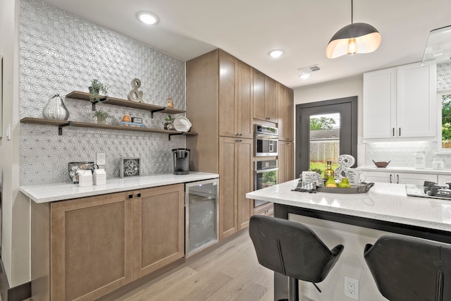 5425 Viking Dr, Houston, TX 77092 - kitchen featuring beverage cooler, light wood-style flooring, decorative backsplash, light stone countertops, and recessed lighting