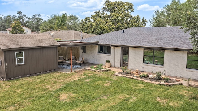 5425 Viking Dr, Houston, TX 77092 - back of house featuring roof with shingles, a patio, a lawn, and brick siding