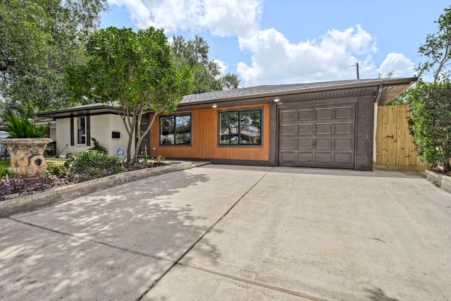 5425 Viking Dr, Houston, TX 77092 - mid-century inspired home featuring concrete driveway, a garage, and brick siding