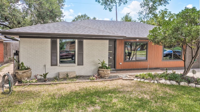 5425 Viking Dr, Houston, TX 77092 - view of front of house featuring a front yard, brick siding, and a shingled roof