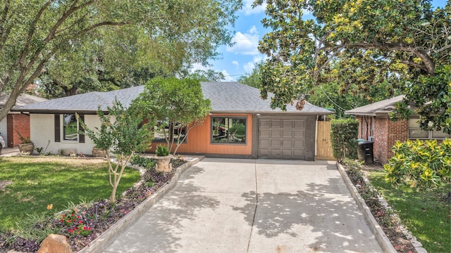 5425 Viking Dr, Houston, TX 77092 - view of front of property featuring concrete driveway, roof with shingles, a front lawn, an attached garage, and brick siding