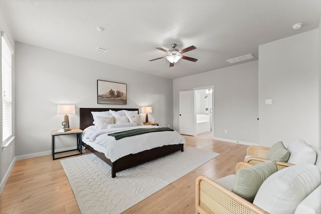 30742 Gardenia Trace Dr, Spring, TX 77386 - bedroom with light wood-type flooring, a ceiling fan, and connected bathroom