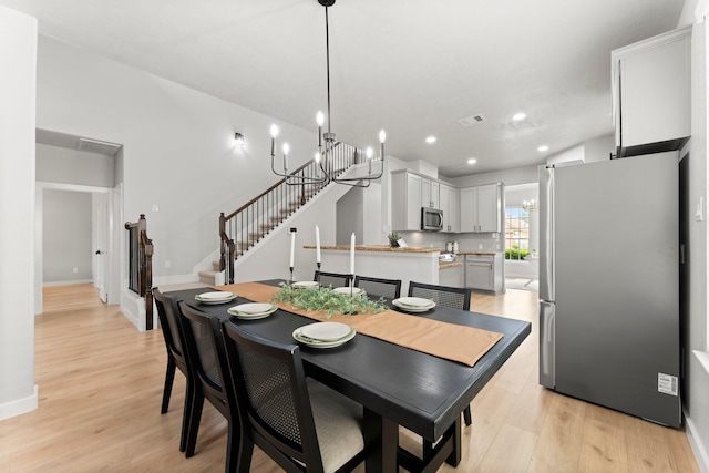 30742 Gardenia Trace Dr, Spring, TX 77386 - dining room featuring light wood-type flooring, stairs, recessed lighting, and a chandelier
