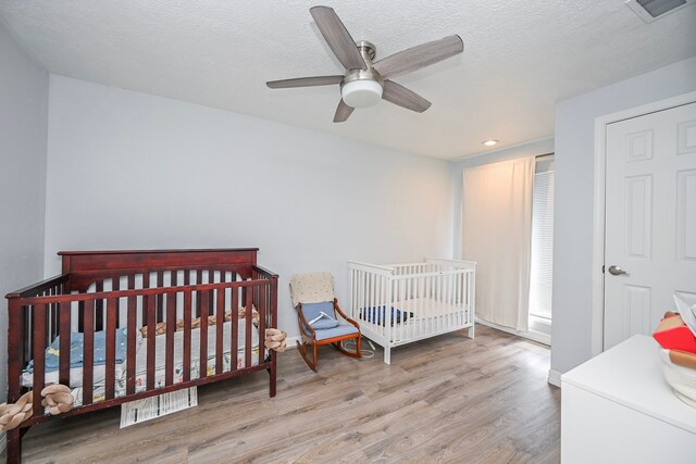11811 Braesridge Dr, Houston, TX 77071 - bedroom featuring wood finished floors, recessed lighting, a ceiling fan, and a textured ceiling
