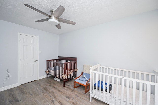 11811 Braesridge Dr, Houston, TX 77071 - bedroom featuring wood finished floors, a ceiling fan, and a textured ceiling