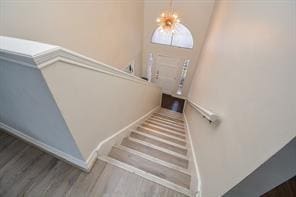 11811 Braesridge Dr, Houston, TX 77071 - stairway with wood finished floors and a chandelier