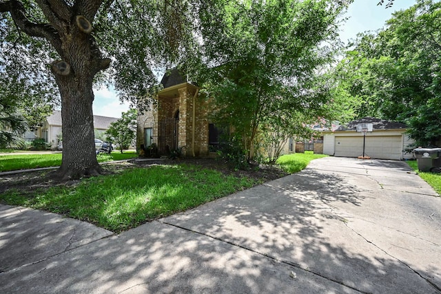 11811 Braesridge Dr, Houston, TX 77071 - obstructed view of property with brick siding, an outbuilding, and driveway