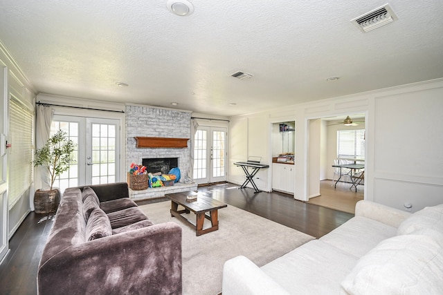 11811 Braesridge Dr, Houston, TX 77071 - living room featuring french doors, dark wood-style flooring, plenty of natural light, a textured ceiling, and ornamental molding