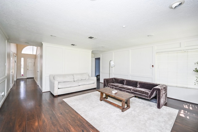 11811 Braesridge Dr, Houston, TX 77071 - living area featuring a decorative wall, a textured ceiling, and dark wood-style flooring