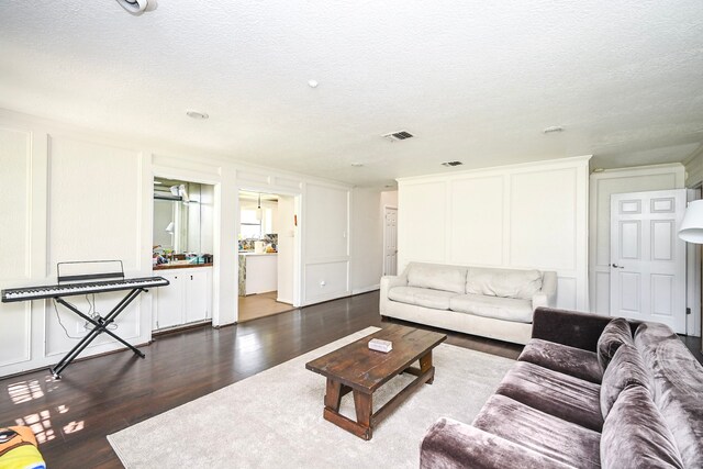 11811 Braesridge Dr, Houston, TX 77071 - living area with a textured ceiling and dark wood-style floors