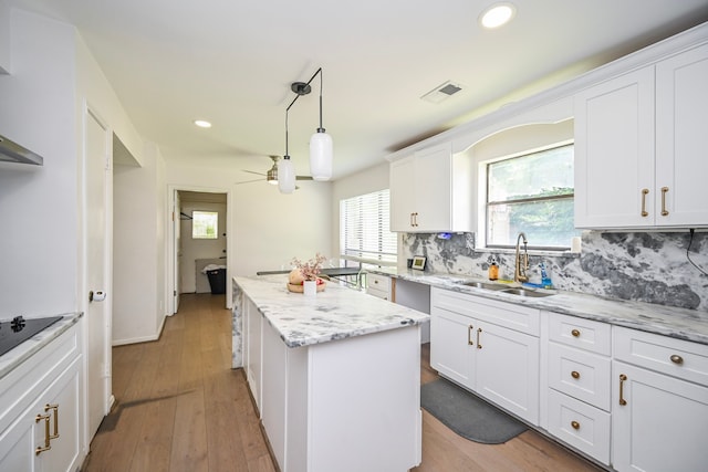11811 Braesridge Dr, Houston, TX 77071 - kitchen featuring a kitchen island, backsplash, a ceiling fan, white cabinetry, and recessed lighting