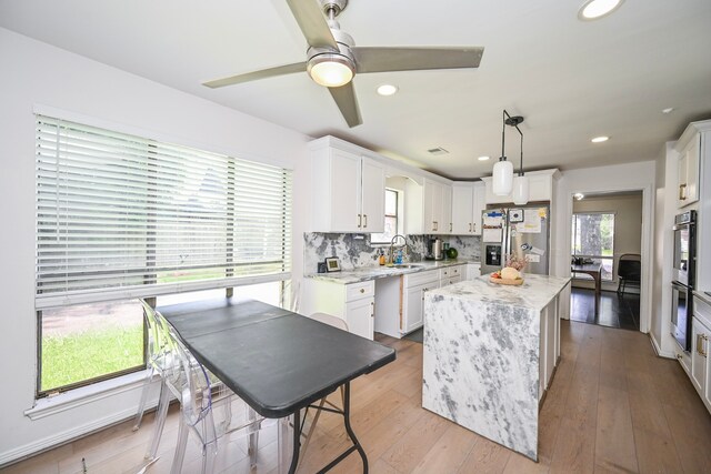 11811 Braesridge Dr, Houston, TX 77071 - kitchen featuring stainless steel appliances, plenty of natural light, white cabinetry, light stone counters, and recessed lighting