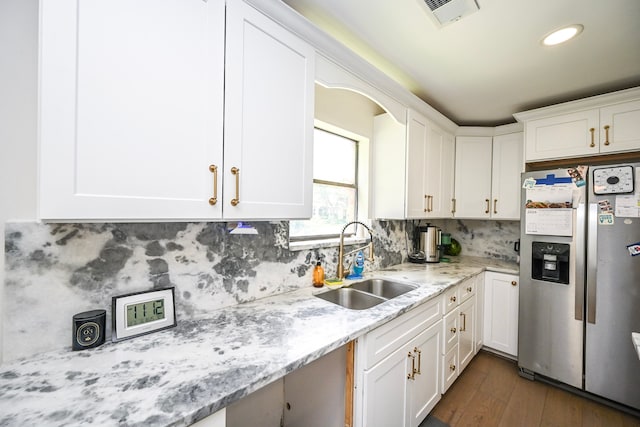 11811 Braesridge Dr, Houston, TX 77071 - kitchen with stainless steel fridge with ice dispenser, white cabinets, dark wood-style floors, and recessed lighting