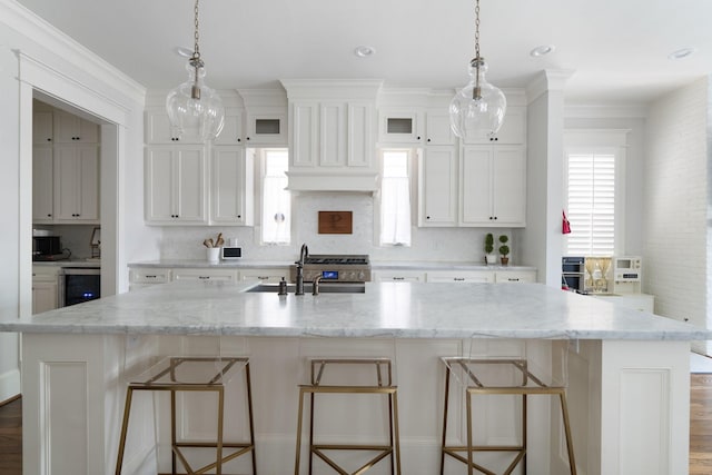 339 W 23rd St Unit A, Houston, TX 77008 - kitchen with tasteful backsplash, beverage cooler, a large island, white cabinetry, and crown molding