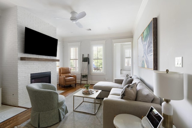 339 W 23rd St Unit A, Houston, TX 77008 - living room featuring wood finished floors, crown molding, a brick fireplace, and ceiling fan
