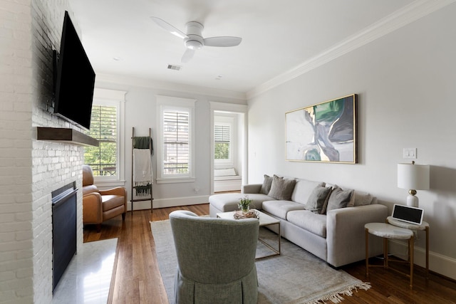 339 W 23rd St Unit A, Houston, TX 77008 - living room featuring wood finished floors, a brick fireplace, crown molding, and ceiling fan