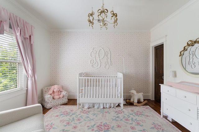 339 W 23rd St Unit A, Houston, TX 77008 - bedroom featuring ornamental molding, wood finished floors, a nursery area, and a chandelier