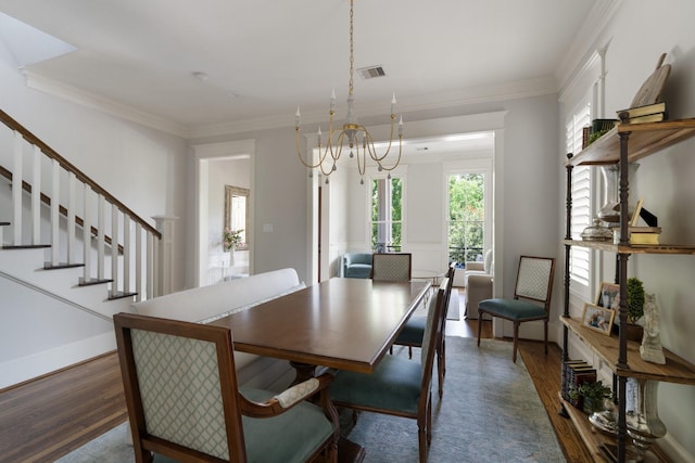 339 W 23rd St Unit A, Houston, TX 77008 - dining space with wood finished floors, a chandelier, plenty of natural light, stairway, and crown molding