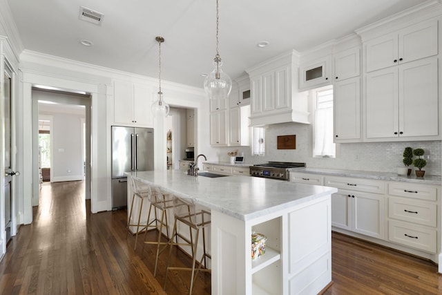 339 W 23rd St Unit A, Houston, TX 77008 - kitchen featuring high end refrigerator, white cabinetry, stove, a kitchen breakfast bar, and dark wood finished floors