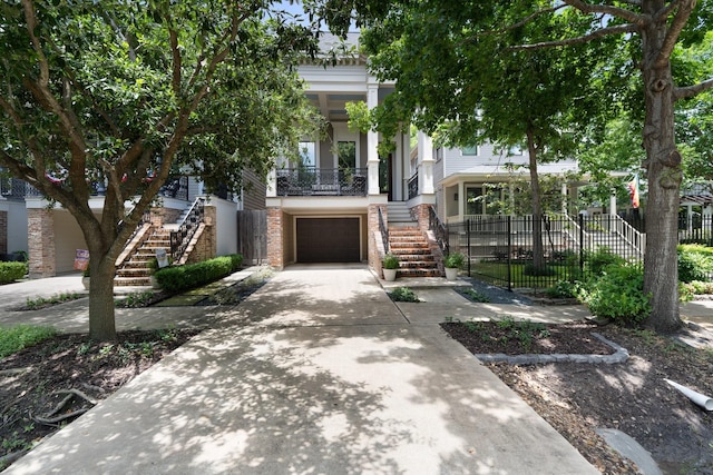 339 W 23rd St Unit A, Houston, TX 77008 - view of front of house with stairway, an attached garage, driveway, and brick siding