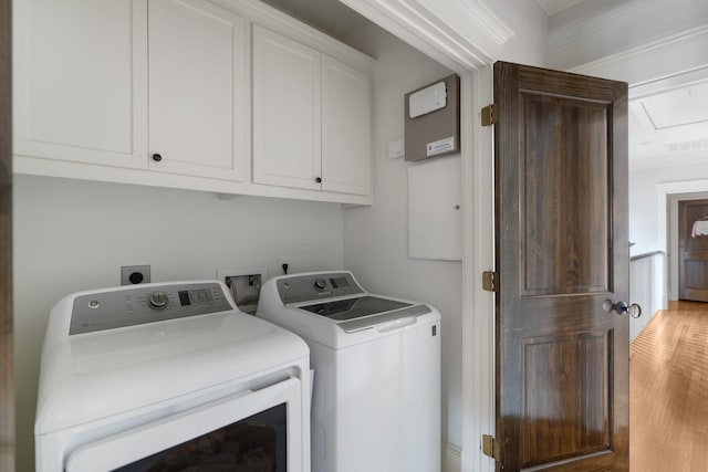 339 W 23rd St Unit A, Houston, TX 77008 - laundry area featuring cabinet space, washer and clothes dryer, and light wood-type flooring