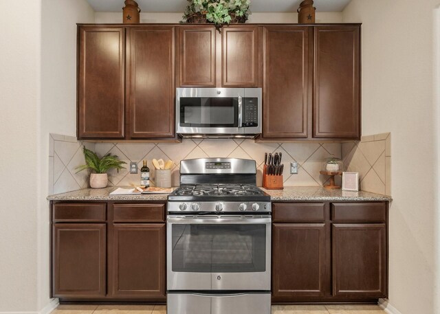 15006 Zenith Glen Ln, Cypress, TX 77429 - kitchen featuring stainless steel appliances, backsplash, and light stone countertops