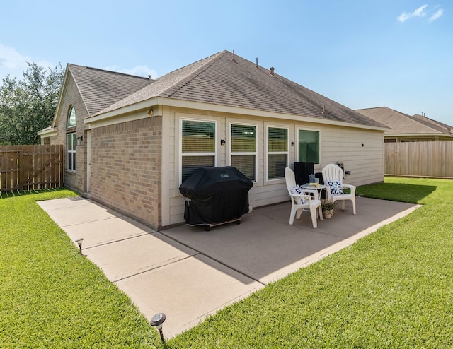 15006 Zenith Glen Ln, Cypress, TX 77429 - rear view of house with roof with shingles, brick siding, and a patio area