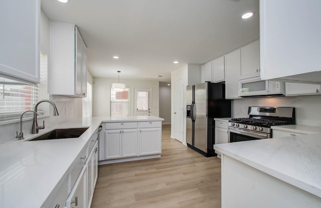 17515 Prospect Meadows Dr, Houston, TX 77095 - kitchen with stainless steel appliances, a peninsula, white cabinetry, light countertops, and recessed lighting