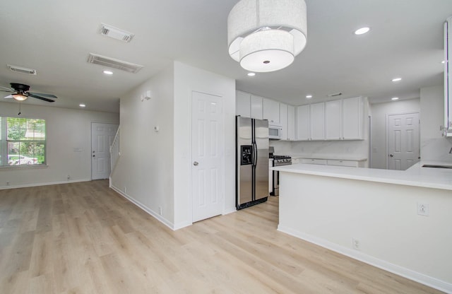 17515 Prospect Meadows Dr, Houston, TX 77095 - kitchen with appliances with stainless steel finishes, light wood-style floors, light countertops, a ceiling fan, and recessed lighting
