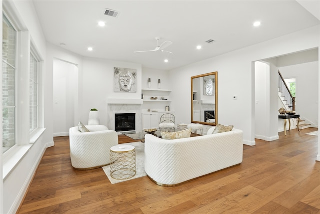 4951 Glenmeadow Dr, Houston, TX 77096 - living room featuring a premium fireplace, light wood-style flooring, stairway, ceiling fan, and recessed lighting