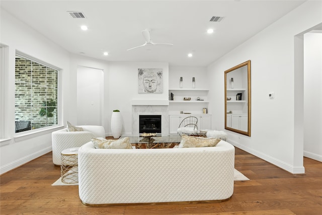 4951 Glenmeadow Dr, Houston, TX 77096 - living area featuring a ceiling fan, a fireplace, wood finished floors, recessed lighting, and built in shelves