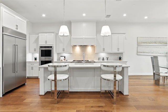 4951 Glenmeadow Dr, Houston, TX 77096 - kitchen with appliances with stainless steel finishes, light countertops, a kitchen bar, decorative backsplash, and recessed lighting