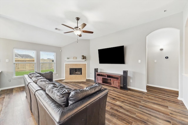 6910 Lamar Park Ln, Houston, TX 77049 - living room with dark wood-style floors, ceiling fan, vaulted ceiling, and a tiled fireplace