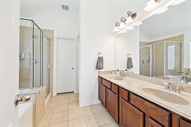 6910 Lamar Park Ln, Houston, TX 77049 - bathroom featuring vaulted ceiling, a stall shower, double vanity, and tile patterned floors