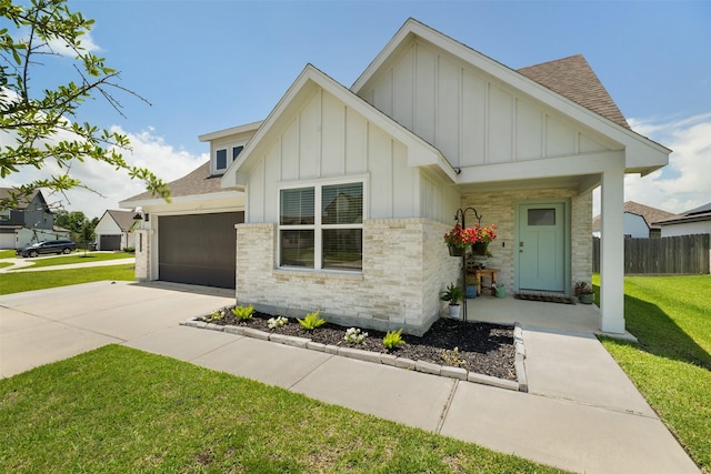 13915 Frio Dr, Baytown, TX 77523 - view of front facade featuring board and batten siding, an attached garage, and a shingled roof