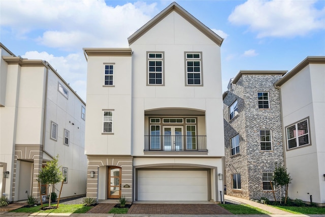 11109 Savannah Woods Ln, Houston, TX 77043 - view of front of home with stucco siding, an attached garage, a balcony, and decorative driveway
