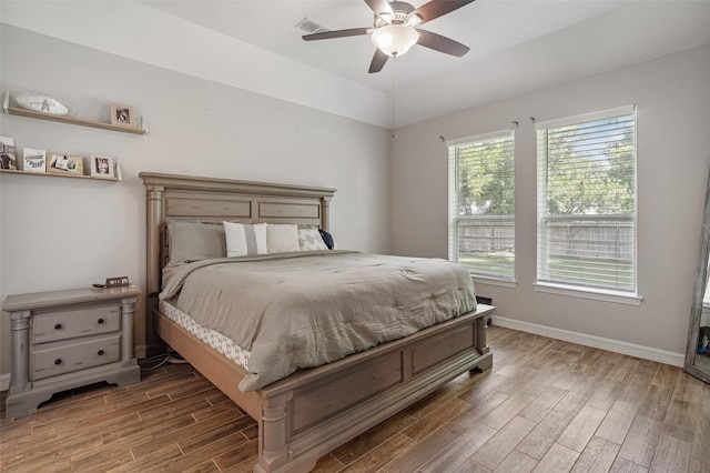 12118 Enclave Ct, Santa Fe, TX 77510 - bedroom with wood finished floors and ceiling fan