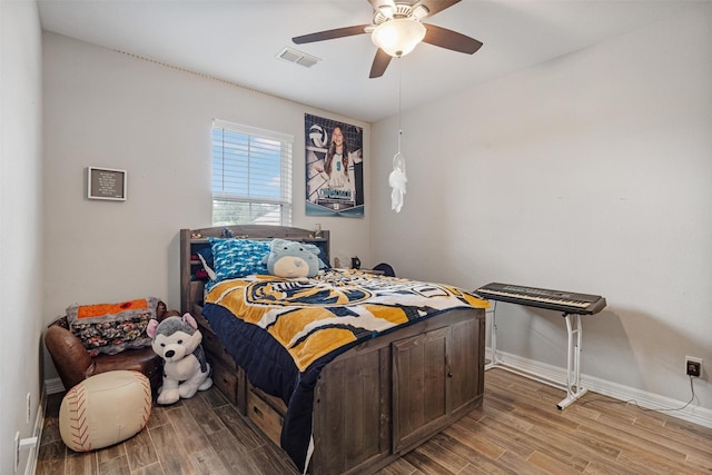 12118 Enclave Ct, Santa Fe, TX 77510 - bedroom with wood finished floors and a ceiling fan