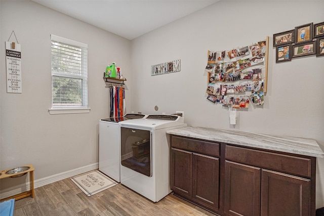 12118 Enclave Ct, Santa Fe, TX 77510 - laundry room with washer and dryer, light wood-style floors, and cabinet space
