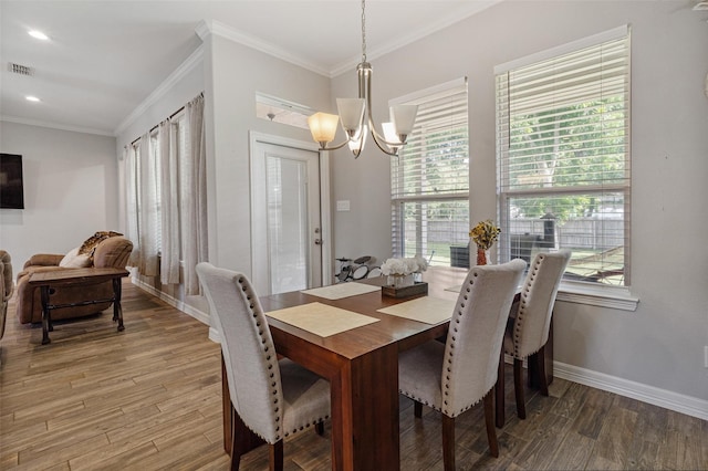 12118 Enclave Ct, Santa Fe, TX 77510 - dining room with a chandelier, crown molding, light wood-type flooring, plenty of natural light, and recessed lighting