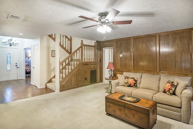22419 Kent Falls Dr, Katy, TX 77450 - living area featuring stairway, a chandelier, ceiling fan, a textured ceiling, and light carpet