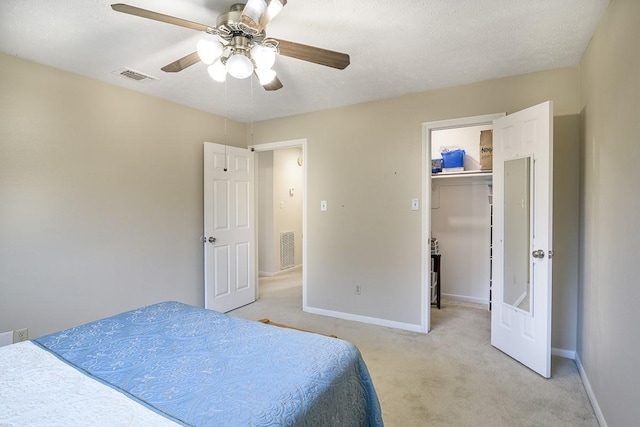 22419 Kent Falls Dr, Katy, TX 77450 - bedroom featuring light colored carpet, a spacious closet, and a ceiling fan